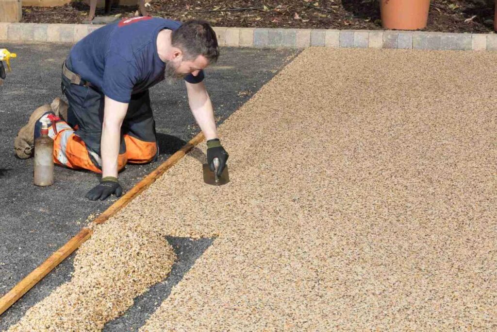 Skilled resin driveway contractors working on a driveway in Swansea
