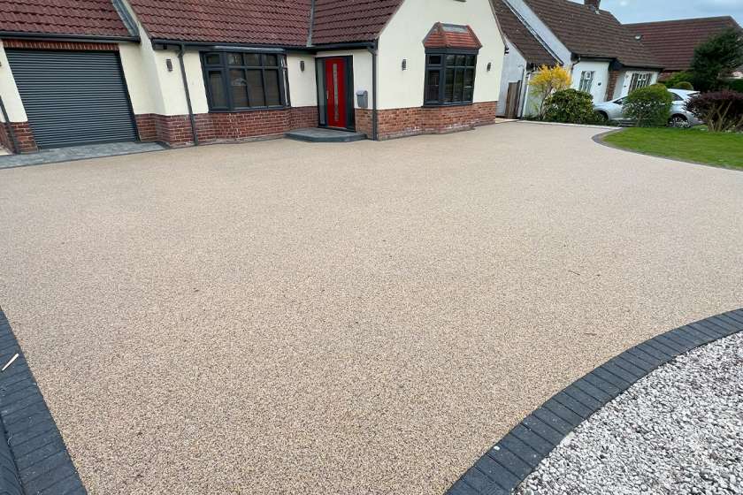 Decorative resin driveway in Gorseinon with custom stone blend and border design