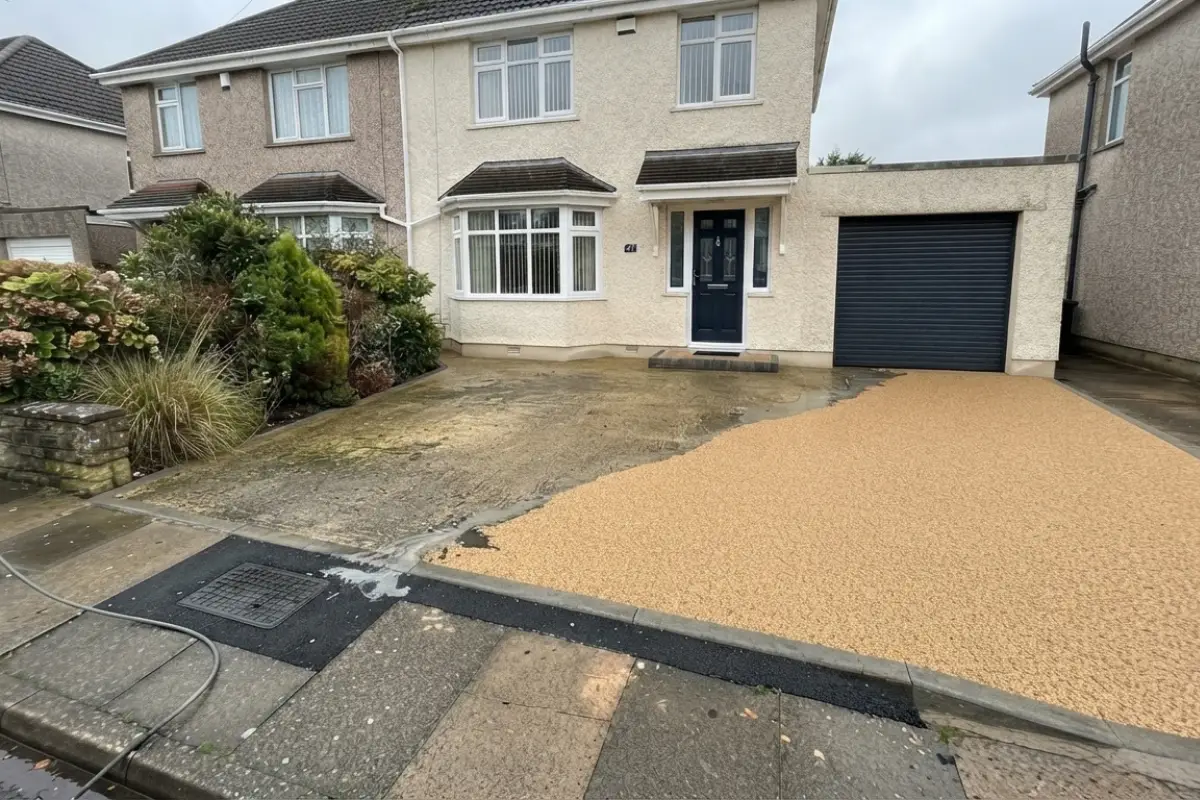 Resin bound driveway cleaning in progress, dirt being pressure washed away